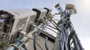 New 5G radio network telecommunication equipment with radio modules and smart antennas mounted on a metal tower