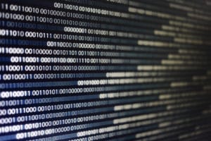 blocks of binary data. Blockchain concept. blue background with computer digital binary code bit number one and zero text. selective focus on the far end of the computer display out of focus in front.