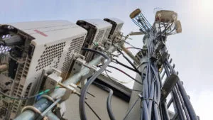 New 5G radio network telecommunication equipment with radio modules and smart antennas mounted on a metal tower